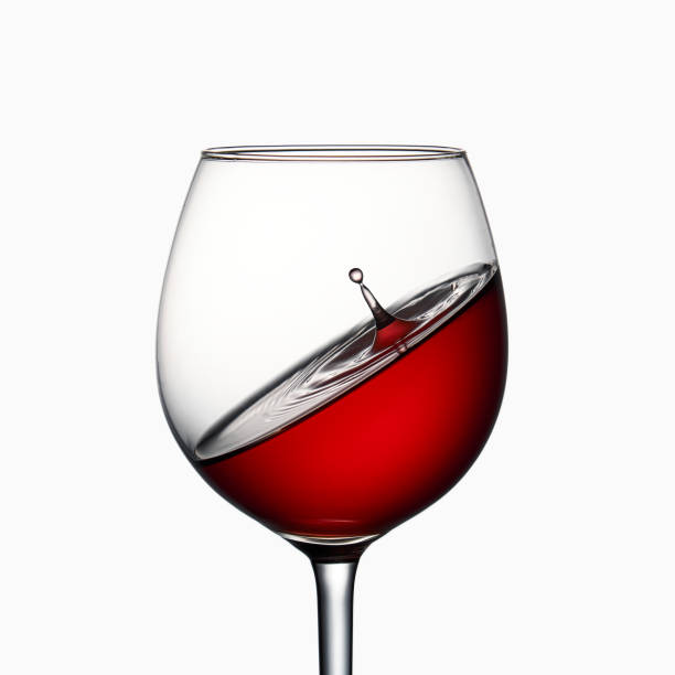 istock Drop falls into a glass of red wine on a white background 1222278862