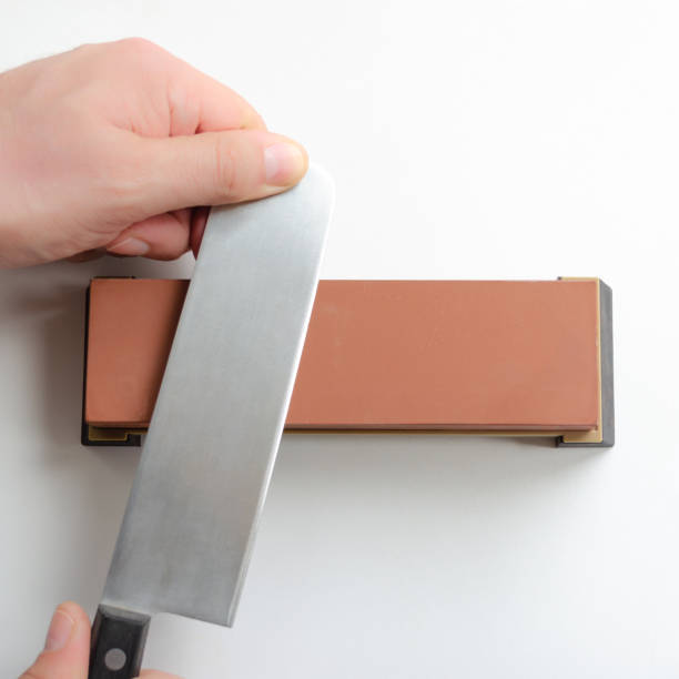 Man Sharpening A Japanese Nakiri Knife With Whetstone Sharpener Or  Grindstone On White Background Stock Photo - Download Image Now - iStock