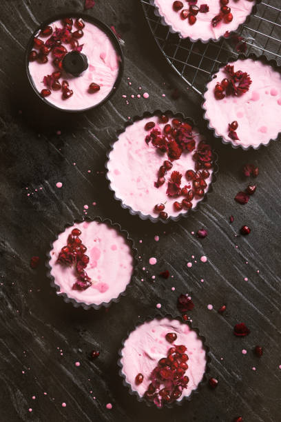 homemade ice cream made out of dairy cream and red fruit topped with flowers and pomegranate. - usa restaurant flower bed beauty in nature imagens e fotografias de stock