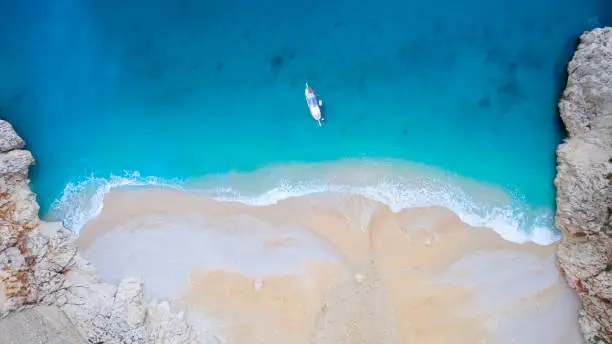 Aerial view of a yacht stopped in a blue sea, Kaputas, Antalya, Turkey.