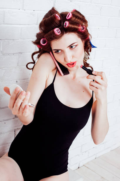 istock Woman with curlers talking on the phone makeup 1222284714