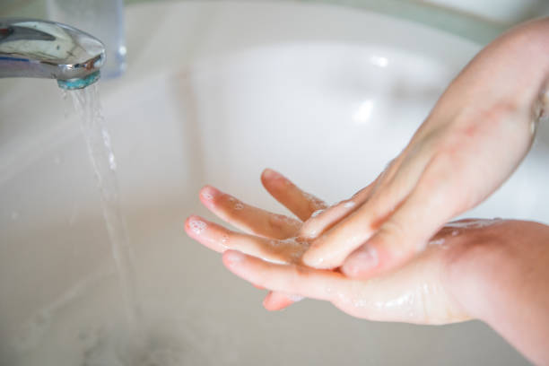 Washing hands rubbing with soap man for corona virus prevention stock photo