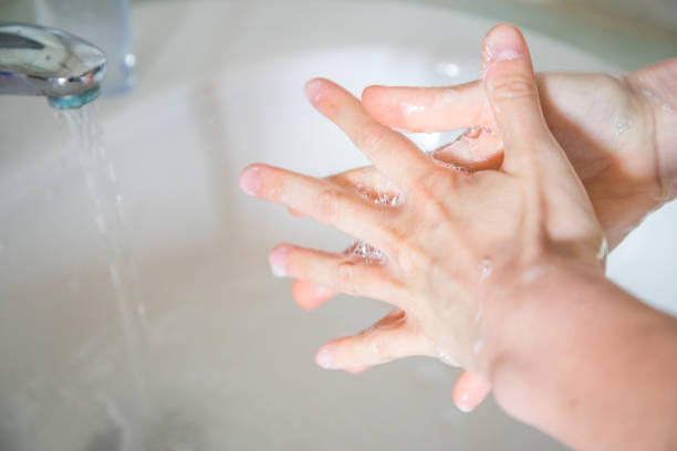 Washing hands rubbing with soap man for corona virus prevention stock photo