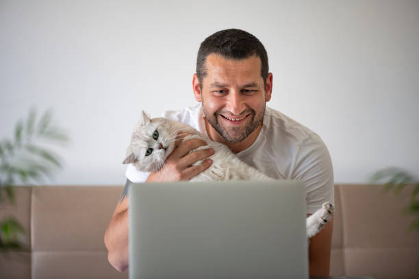 istock Man Making Video Call With His Cat 1222288393