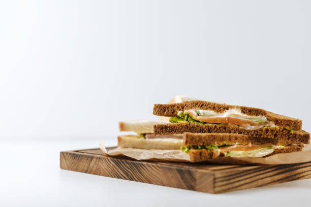 istock Dark and white bread sandwiches on a wooden board. 1222288924