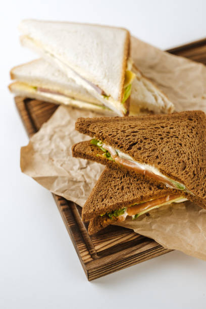 istock Dark and white bread sandwiches on a wooden board. 1222289883
