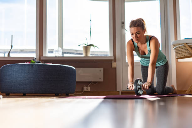 istock Sports woman is doing ab roller exercise. 1222290793