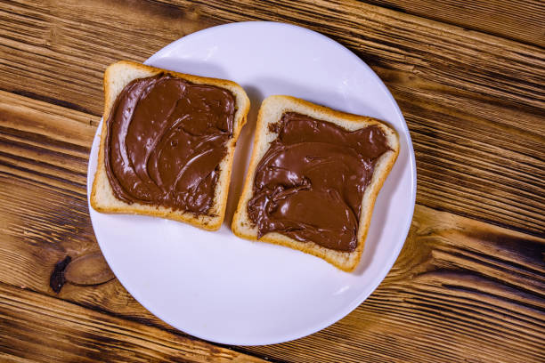 istock Two sandwiches with chocolate spread on a white plate. Top view 1222295850