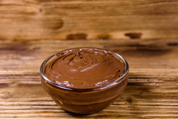 istock Glass bowl with chocolate spread on a wooden table 1222295853