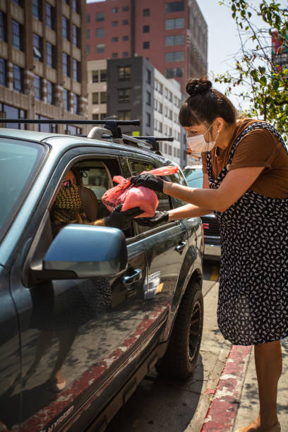 istock Masked Delivery Driver in Car Accepting Order from Restaurant Worker 1222296702