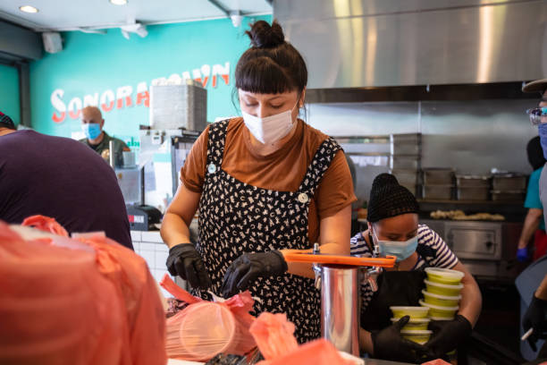 istock Masked Workers in Mexican Restaurant Assembling Take-Out Orders During Covid-19 Lockdown 1222296714