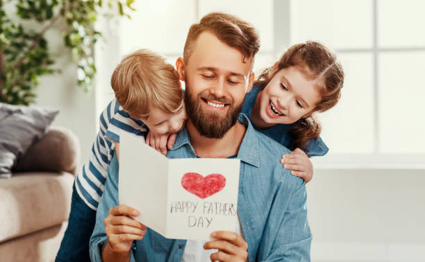 istock Happy father receiving greeting card from kids 1222297744