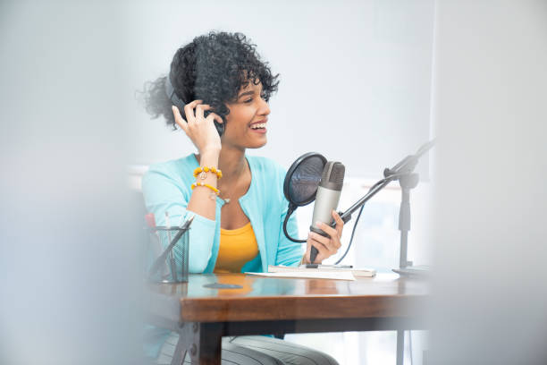 istock Good looking young black female making an online podcast recording 1222299832