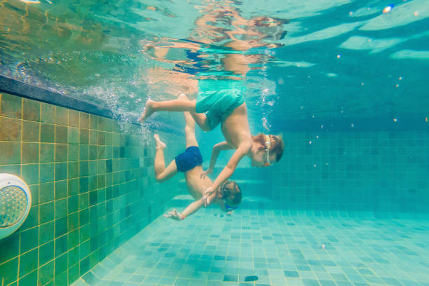 istock two children diving in masks underwater in pool 1222302270