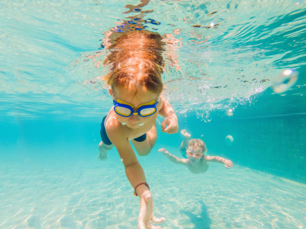 istock two children diving in masks underwater in pool 1222302273