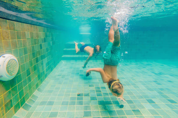 istock two children diving in masks underwater in pool 1222302278