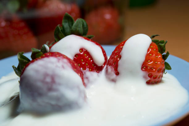 istock Plate of strawberries with cream in macro view 1222303439
