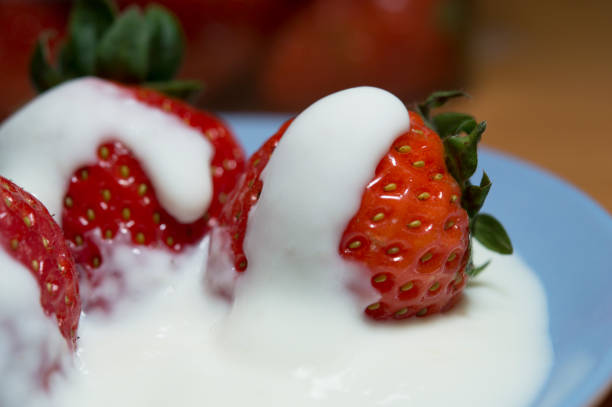 istock Plate of strawberries with cream in macro view 1222303445