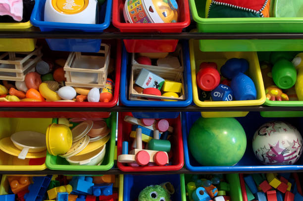 a variety of childrens toys in bins - brinquedo imagens e fotografias de stock
