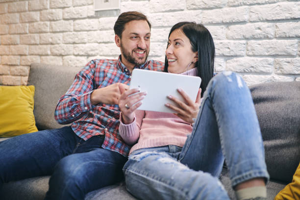 istock Cheerful couple enjoying leisure time at home 1222309663