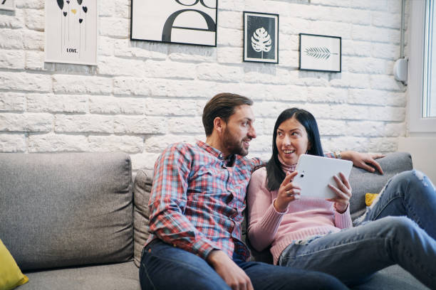 istock Beautiful couple relaxing on a sofa at home 1222309720