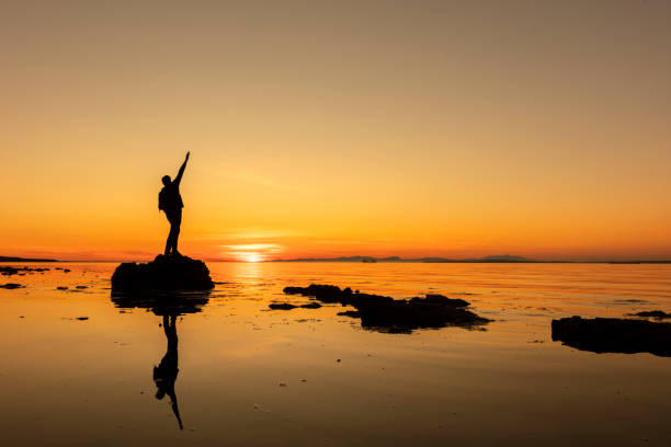 istock Success with arms outstretched celebrate mountains sunrise 1222310740
