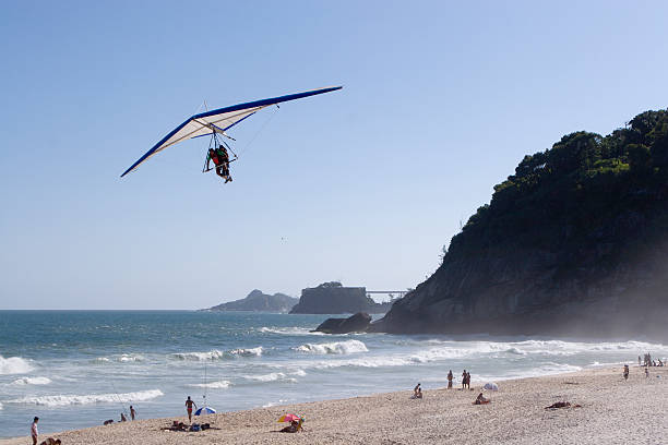 Composite image of pig flying with hang glider through lofty clouds