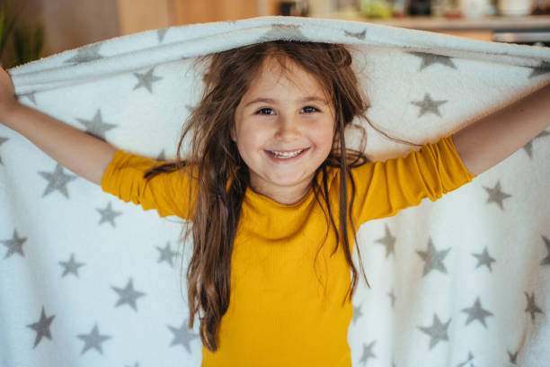 istock Playful child having fun wearing a blanket as a cape at home 1222314731