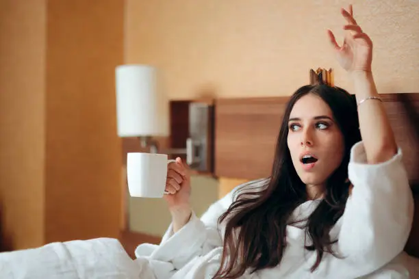 Photo of Birthday Woman  Wearing Crown Asking for More Coffee in Bed