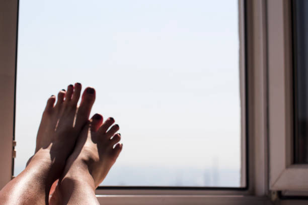 istock young woman's feet in an open window 1222319326