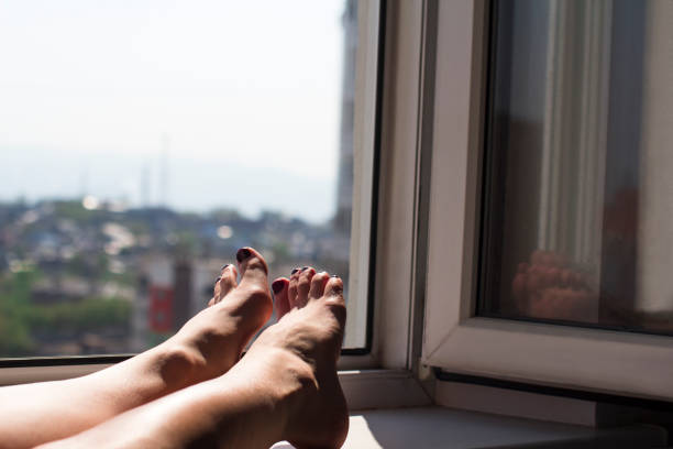 istock young woman's feet in an open window 1222319329