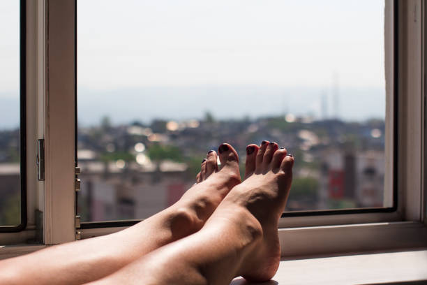 istock young woman's feet in an open window 1222319330