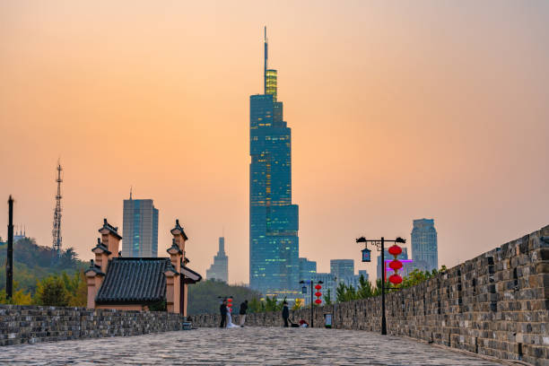 The ancient city wall and Zifeng Tower This is a view of the ancient city wall and the Zifeng Tower skyscraper during sunset on November 08, 2019 in Nanjing jiangsu province photos stock pictures, royalty-free photos & images