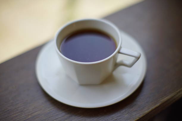One cup of black coffee and one cup of white coffee