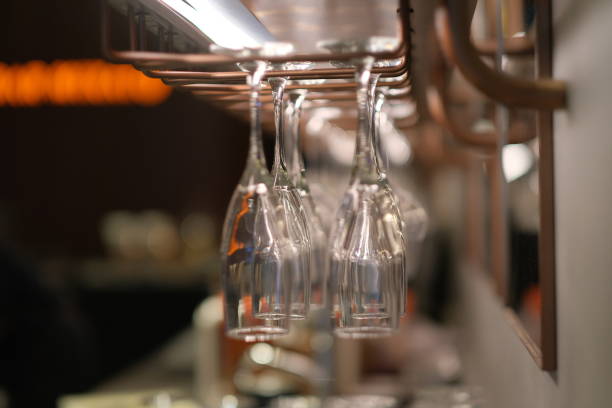close up upside down drinking glasses in bar at night.