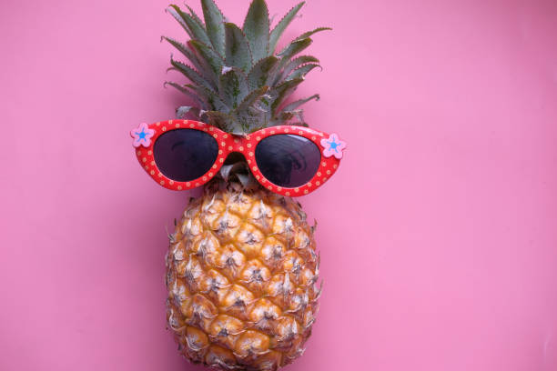 istock Funny pineapple with sunglasses on color background 1222336701