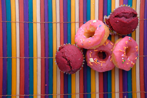 Close up of colorful donuts on wooden table