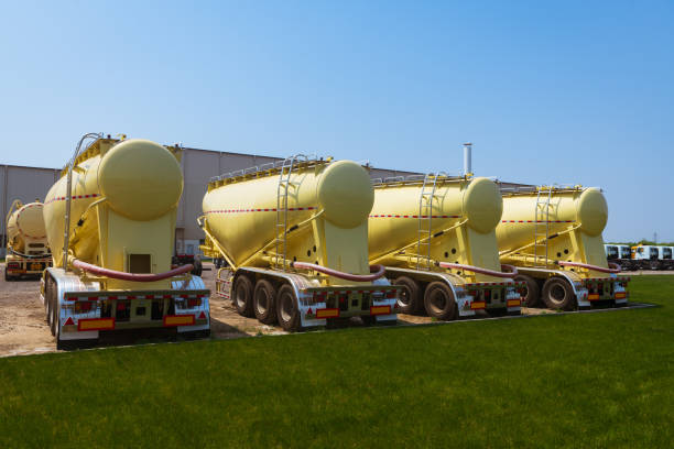 cement tankers line up in front of the grass - truck motion road cement truck imagens e fotografias de stock