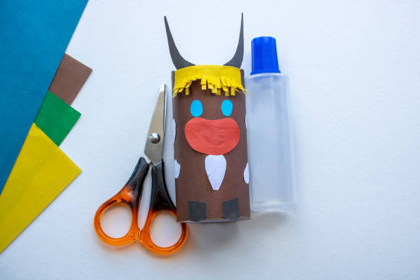istock Step-by-step instructions. Step 5 Create a paper craft from a toilet sleeve. Brown bull. 2021.Chinese new year of the White Bull. Funny Halloween cute monster diy colored paper scissors glue. Children's educational education is an idea for creativity 1222340617