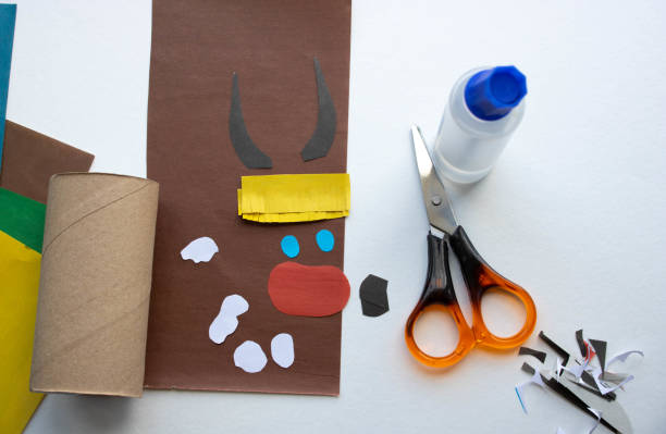 istock Step-by-step instructions. Step 2 Create a paper craft from a toilet sleeve. Brown bull. 2021.Chinese new year of the White Bull. Funny Halloween cute monster diy colored paper scissors glue. Children's educational education is an idea for creativity 1222340630