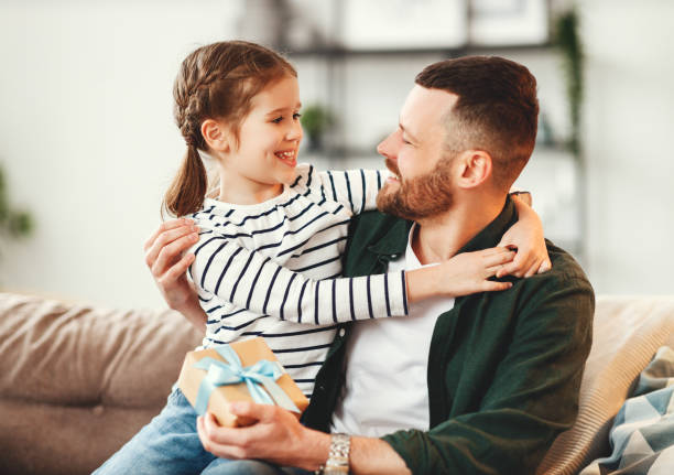 istock Cute girl hugging happy father with gift 1222340822
