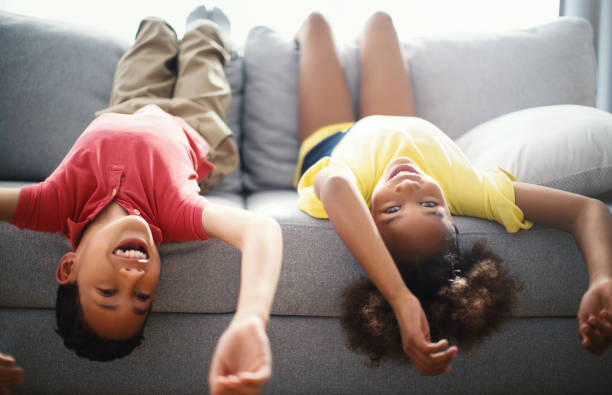 istock Children lying down on the sofa at home. 1222340827