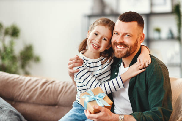 istock Cute girl hugging happy father with gift 1222340850