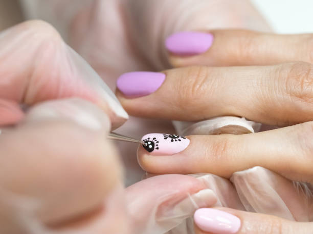 istock Drawing on your nails. Creative manicure with painted coronavirus on the nails, soft focus, close up 1222341714