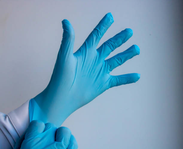 istock hand in a blue glove on a white background 1222342386