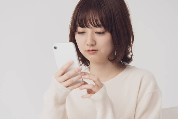 istock asian young woman uses a smartphone 1222346418