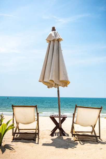 istock Two deckchair umbrella facing out sea on idyllic beach 1222346555