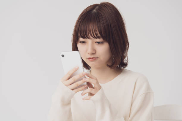 istock asian young woman uses a smartphone 1222346645
