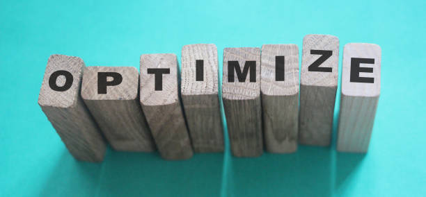 istock Optimize word on wooden blocks with letters, search engine optimization SEO concept, top view on cyan background 1222346661