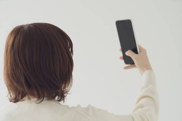 istock asian young woman uses a smartphone 1222347689